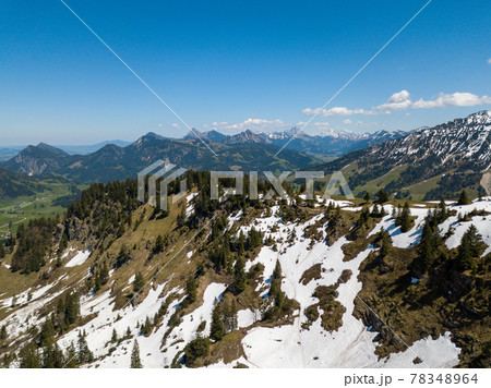Aerial view on the Allgau Alps in Bavaria, Germany, on a sunny day in May with last snow in the higher mountains Aerial view on the Allgau Alps in Bavaria, Germany, on a sunny day in May with last snow in the higher mountains 78348964