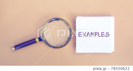 Magnifying glass and a note with the word Examples. Example, instance, sample. Business, marketing and training concept. Flat lay Magnifying glass and a note with the word Examples. Example, instance, sample. Business, marketing and training concept. Flat lay 78350622