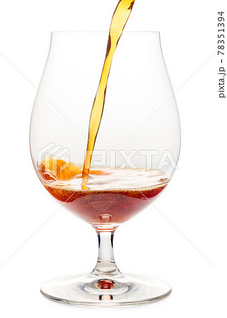 Pouring dark ale beer into a tulip glass isolated Pouring dark ale beer into a tulip glass isolated 78351394