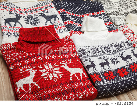 Collection of knitted Christmas turtleneck sweaters folded in a store Collection of knitted Christmas turtleneck sweaters folded in a store 78353104