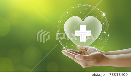 Hand offer hospital heart with white cross on green background. Family life insurance, Medical care insurance, and Business healthy concepts.  78358400