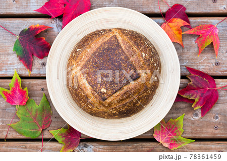 Homemade artisan bread on a round plate with fall decorations 78361459