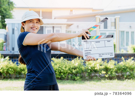 Asian woman holding film slate colors board for movie cinema and television industry Asian woman holding film slate colors board for movie cinema and television industry 78364096