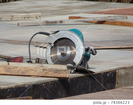KUALA LUMPUR, MALAYSIA -JUNE 18, 2020: Mobile circular cutter used by the carpenter to cut plywood at the construction site.   78366223
