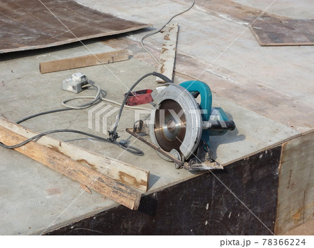 KUALA LUMPUR, MALAYSIA -JUNE 18, 2020: Mobile circular cutter used by the carpenter to cut plywood at the construction site.   78366224