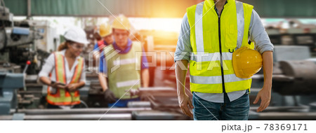 Man engineering wearing uniform safety in factory with blurred background team worker at industry. Man engineering wearing uniform safety in factory with blurred background team worker at industry. 78369171