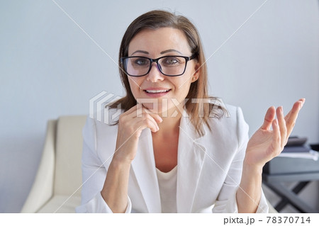Video call, video conference, mature business woman looking at webcam, closeup face 78370714