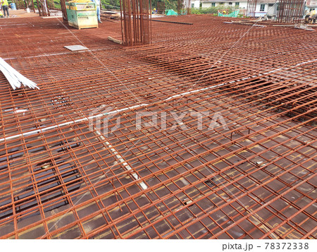 KUALA LUMPUR, MALAYSIA -NOVEMBER 23, 2020: Building floor slab under construction. Construction workers fabricating the timber formwork and installing the steel reinforcement bar. KUALA LUMPUR, MALAYSIA -NOVEMBER 23, 2020: Building floor slab under construction. Construction workers fabricating the timber formwork and installing the steel reinforcement bar. 78372338