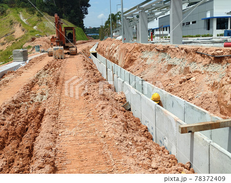 SELANGOR, MALAYSIA -JANUARY 20, 2021: Concrete box culvert drain under construction at the construction site. It is used to channel stormwater to prevent flash floods. SELANGOR, MALAYSIA -JANUARY 20, 2021: Concrete box culvert drain under construction at the construction site. It is used to channel stormwater to prevent flash floods. 78372409
