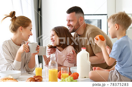 Young happy family eating morning breakfast together at home Young happy family eating morning breakfast together at home 78375283