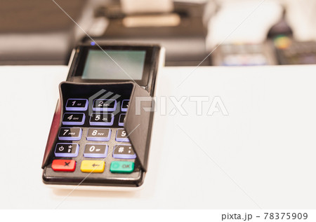 Card reader machine at cashier counter in cafe. 78375909