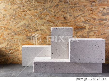 Aerated concrete block cube or bricks near osb wall background texture. Construction concept Aerated concrete block cube or bricks near osb wall background texture. Construction concept 78376913