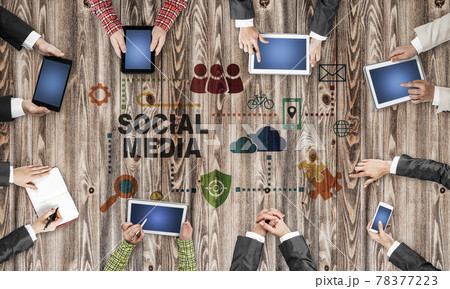 Top view of businesspeople sitting at table and using gadgets 78377223