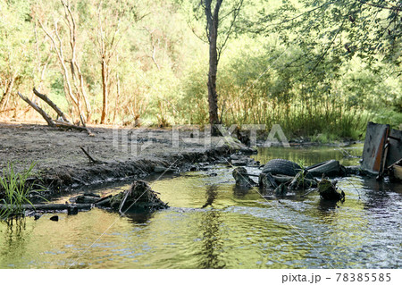 environmental pollution; garbage in the bed of the small river and the bank poisoned by industrial effluents environmental pollution; garbage in the bed of the small river and the bank poisoned by industrial effluents 78385585
