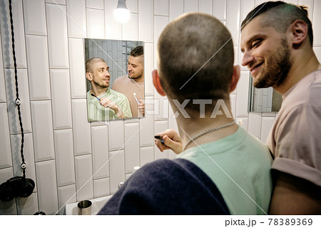 Happy young gay man looking at his boyfriend 78389369