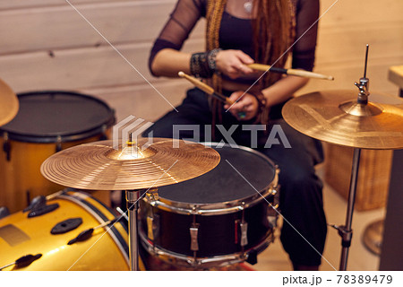 Drum set and young female with drumsticks Drum set and young female with drumsticks 78389479