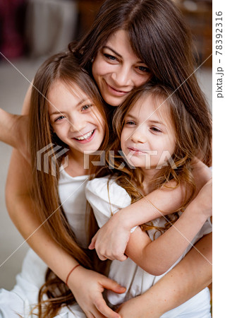 mom hugs daughters rides on a swing in the loft. mother's day mom hugs daughters rides on a swing in the loft. mother's day 78392316