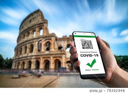 Traveler holds vaccine passport certificate to show COVID 19 vaccination status Traveler holds vaccine passport certificate to show COVID 19 vaccination status 78392948