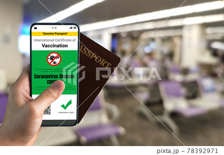 Traveler holds vaccine passport certificate to show COVID 19 vaccination status Traveler holds vaccine passport certificate to show COVID 19 vaccination status 78392971
