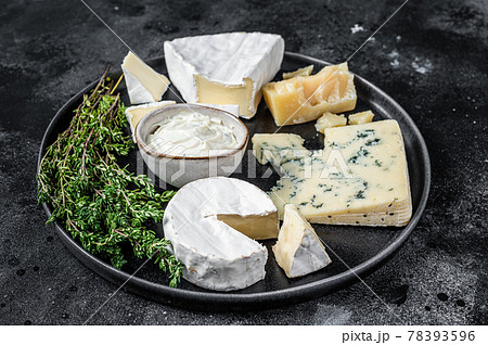 French Cheese plate. Camembert, Brie, Gorgonzola and blue cream cheese. Black background. Top view French Cheese plate. Camembert, Brie, Gorgonzola and blue cream cheese. Black background. Top view 78393596