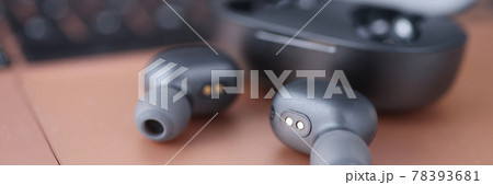 Wireless headphones next to the box closeup 78393681