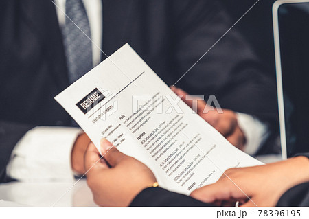 Human resources department manager reads CV resume 78396195