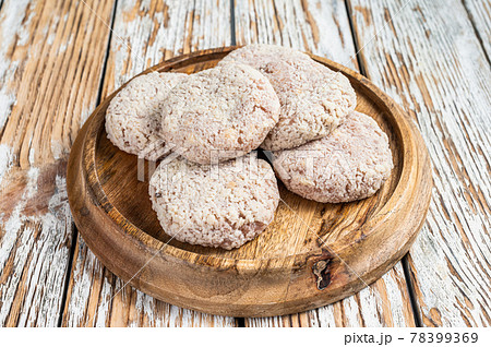 Raw chicken patty cutlet with breadcrumbs. White wooden background. Top view 78399369