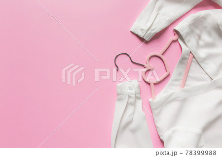 Black Friday or clothing industry concept, pink background, hanger, white blouse 78399988