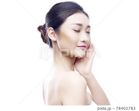 studio portrait of a young asian woman, hand on chin, eyes closed, side view, isolated on white studio portrait of a young asian woman, hand on chin, eyes closed, side view, isolated on white 78402783