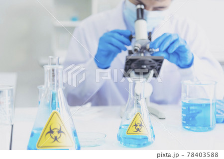 Male Scientist look into Microscope research in science laboratory. Asian scientist looking equipment laboratory chemistry labs. Covid-19 coronavirus biochemistry research experiment vaccine concept 78403588