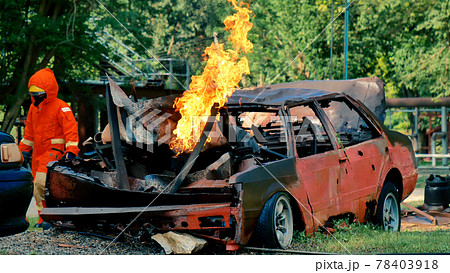 Firefighter fighting with flame using fire hose chemical water foam spray engine. Fireman wear hard hat, body safe suit uniform for protection. Rescue training in fire fighting extinguisher Firefighter fighting with flame using fire hose chemical water foam spray engine. Fireman wear hard hat, body safe suit uniform for protection. Rescue training in fire fighting extinguisher 78403918