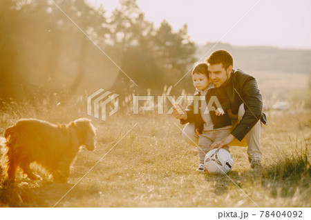 Cute family playing in a autumn field Cute family playing in a autumn field 78404092