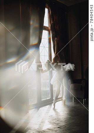 Ballerina posing in front of white background 78404543