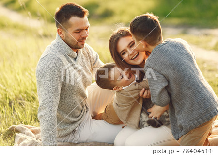 Cute family playing in a summer field 78404611