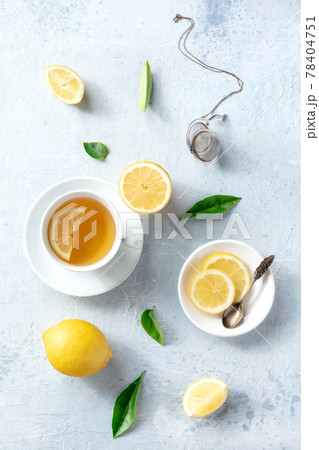 Lemon tea in a cup, overhead flat lay shot on a slate background. Organic lemons 78404751