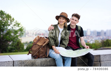 Young couple travelers with map in city on holiday, resting and planning. Young couple travelers with map in city on holiday, resting and planning. 78406086
