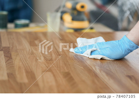 Apply wood care oil to product closeup Apply wood care oil to product closeup 78407105