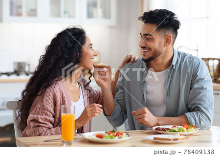 Happy young arab couple enjoying eating their breakfast together at home 78409138