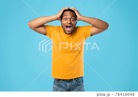 Shocked African American Guy Shouting Touching Head Over Blue Background Shocked African American Guy Shouting Touching Head Over Blue Background 78410048