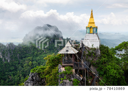 Whtie temple and pagoda on top of mountain in Thailand. 78410869