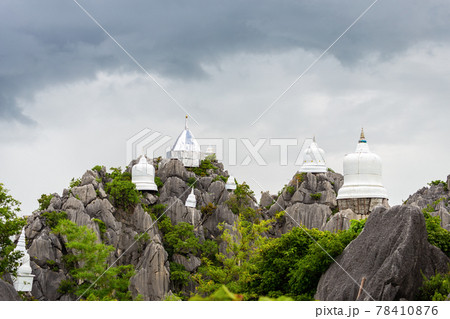 Whtie temple and pagoda on top of mountain in Thailand. 78410876
