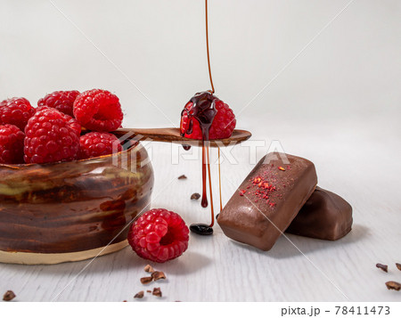 Dark handmade chocolate with raspberries and syrup Dark handmade chocolate with raspberries and syrup 78411473