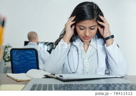 Stressed young general practitioner 78411512