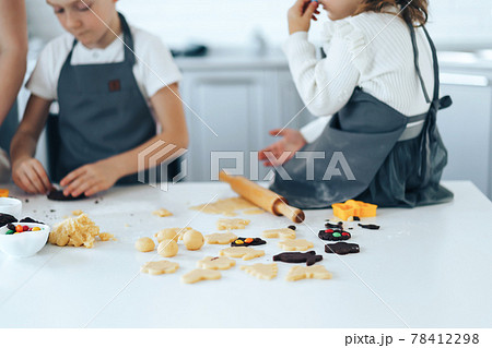 Mother of many children cooking sweet cookies at light white kitchen. 78412298