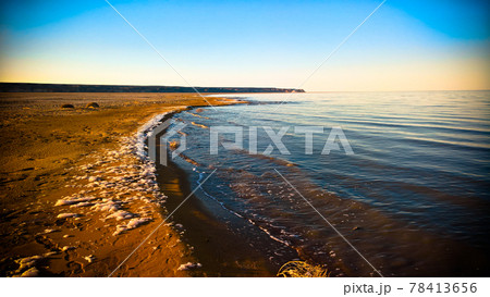 Sea foam at the beach of the Aral Sea near Aktumsuk cape at sunset, Karakalpakstan, Uzbekistan 78413656
