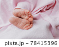 Baby's feet under a pink blanket 78415396