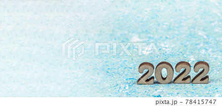 Numerals 2022 on blue background. Wooden digits 2022. Numerals 2022 on blue background. Wooden digits 2022. 78415747