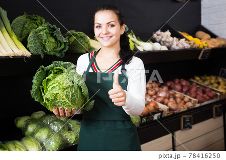 Seller displaying assortment of grocery shop Seller displaying assortment of grocery shop 78416250