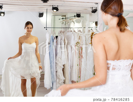 Woman dressed in white gown Woman dressed in white gown 78416285