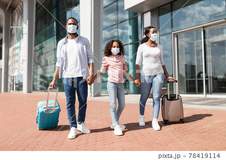 Happy black family traveling with kid, walking out airport Happy black family traveling with kid, walking out airport 78419114
